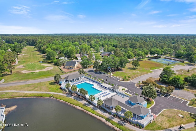 1710 Deerfield Ct SW Unit 4A, Ocean Isle Beach, NC 28469 - aerial view of a forest, a pool area, a nearby body of water, and a local golf course