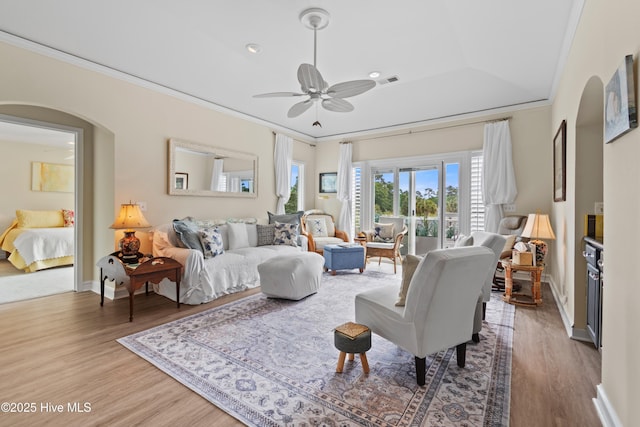 1710 Deerfield Ct SW Unit 4A, Ocean Isle Beach, NC 28469 - living room featuring arched walkways, wood finished floors, ceiling fan, ornamental molding, and baseboards
