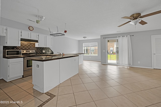 2910 Mulberry Ln Unit B, Greenville, NC 27858 - kitchen with stainless steel appliances, dark countertops, under cabinet range hood, open floor plan, and decorative backsplash