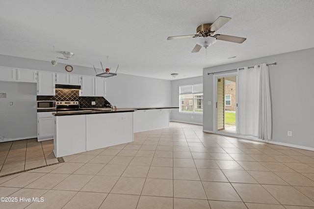 2910 Mulberry Ln Unit B, Greenville, NC 27858 - kitchen with open floor plan, appliances with stainless steel finishes, under cabinet range hood, backsplash, and dark countertops