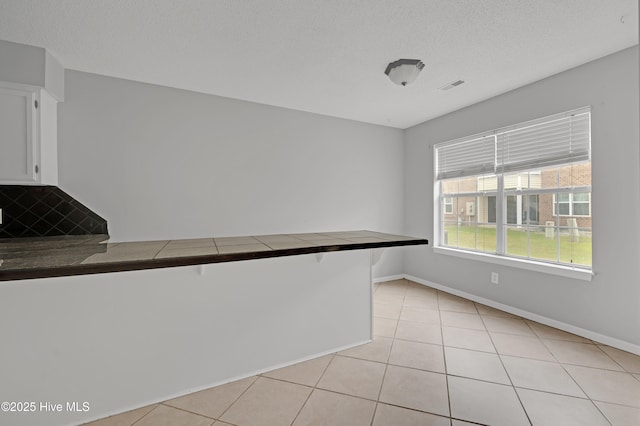 2910 Mulberry Ln Unit B, Greenville, NC 27858 - spare room with light tile patterned flooring and a textured ceiling