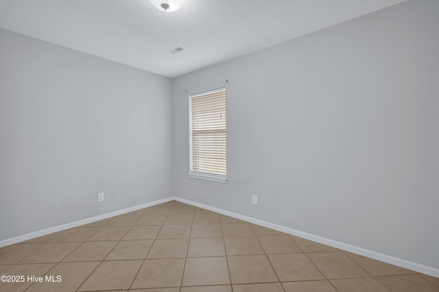 2910 Mulberry Ln Unit B, Greenville, NC 27858 - empty room featuring a textured ceiling and light tile patterned floors