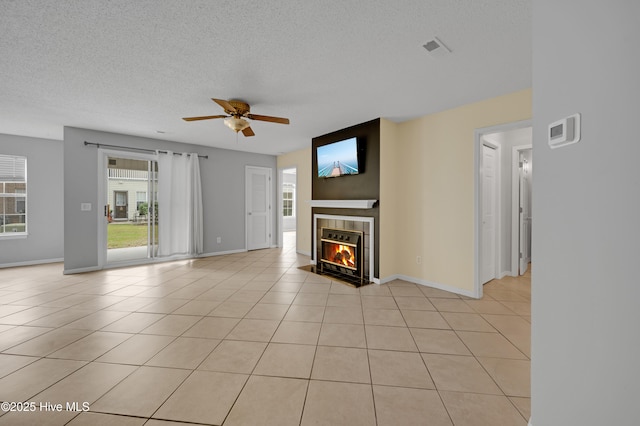 2910 Mulberry Ln Unit B, Greenville, NC 27858 - unfurnished living room with ceiling fan, a fireplace, a textured ceiling, and light tile patterned floors