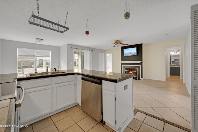 2910 Mulberry Ln Unit B, Greenville, NC 27858 - kitchen featuring dishwasher, white range, ceiling fan, light tile patterned flooring, and a tile fireplace