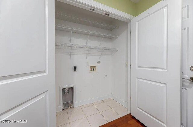 laundry room with laundry area, hookup for a washing machine, hookup for an electric dryer, light tile patterned floors, and hookup for a gas dryer
