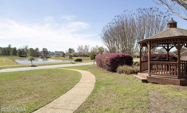 view of yard featuring a gazebo and a water view
