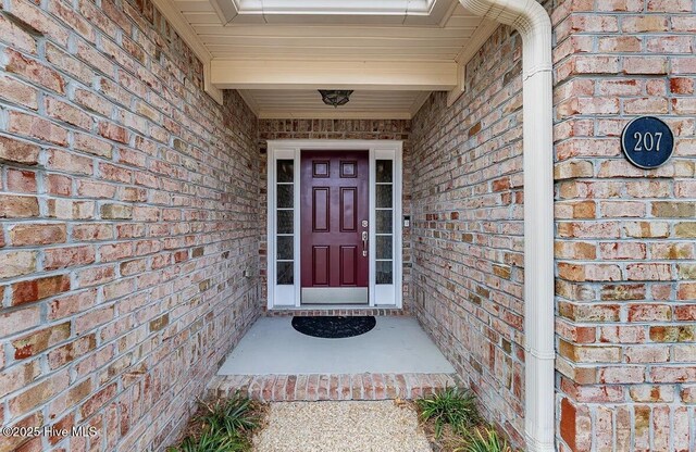 entrance to property with brick siding