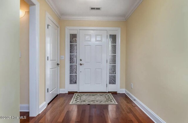 entrance foyer featuring baseboards, visible vents, dark wood-style floors, and ornamental molding