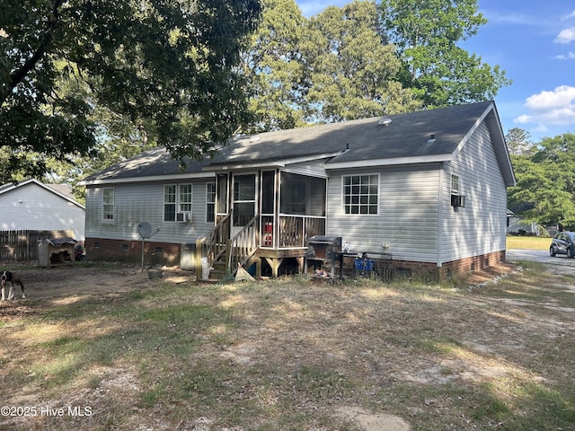 view of front of home with crawl space, a shingled roof, and a sunroom