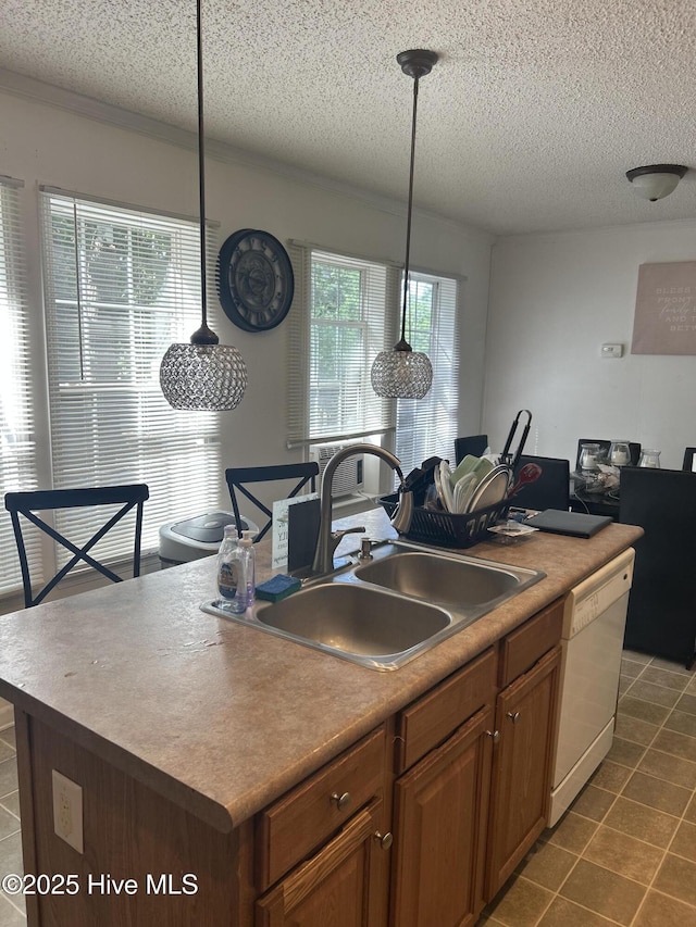 kitchen with hanging light fixtures, a sink, dishwasher, a textured ceiling, and dark tile patterned flooring
