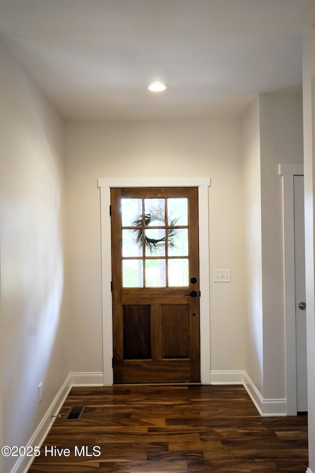 doorway to outside with recessed lighting, baseboards, and dark wood-type flooring