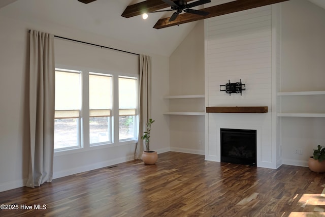 unfurnished living room featuring a large fireplace, ceiling fan, dark wood-style floors, and beamed ceiling