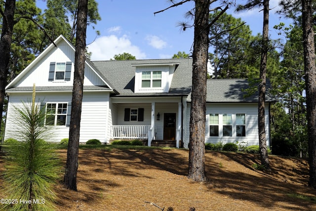 view of front of home featuring a shingled roof and a porch