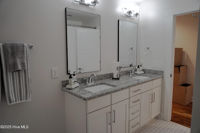 bathroom featuring double vanity and a sink