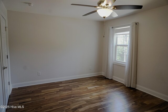 empty room with baseboards, ceiling fan, and wood finished floors