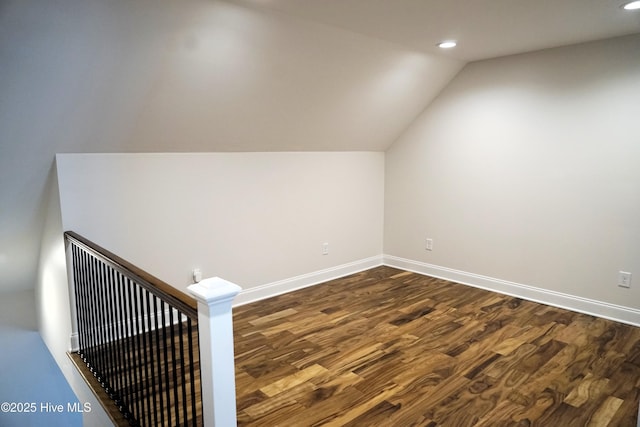 additional living space featuring recessed lighting, baseboards, dark wood finished floors, and vaulted ceiling