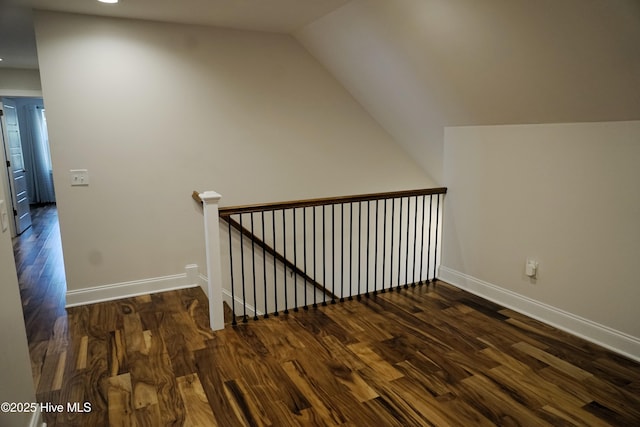 additional living space featuring recessed lighting, baseboards, lofted ceiling, and dark wood-type flooring