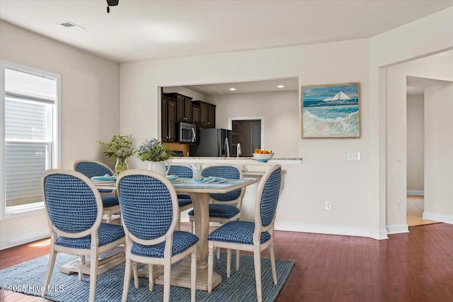 dining space with recessed lighting, baseboards, visible vents, and hardwood / wood-style flooring