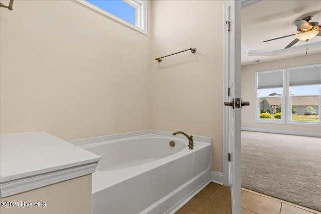 bathroom featuring tile patterned floors, ceiling fan, baseboards, and a garden tub