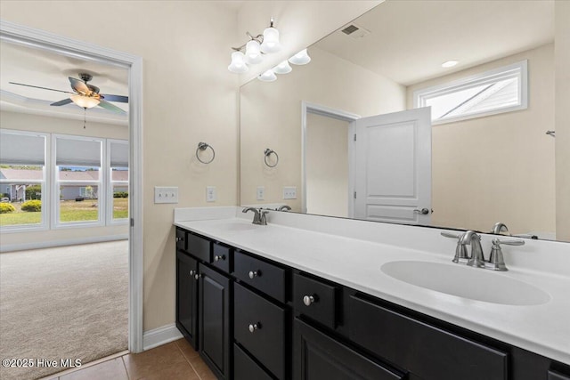 bathroom with a sink, tile patterned floors, a ceiling fan, and double vanity