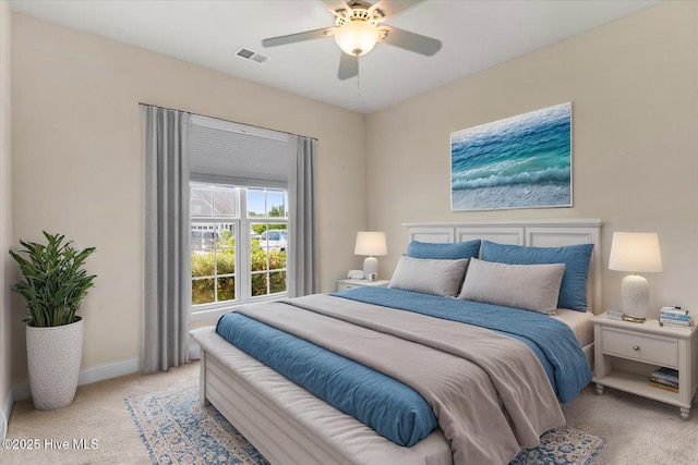 bedroom with visible vents, baseboards, ceiling fan, and light carpet