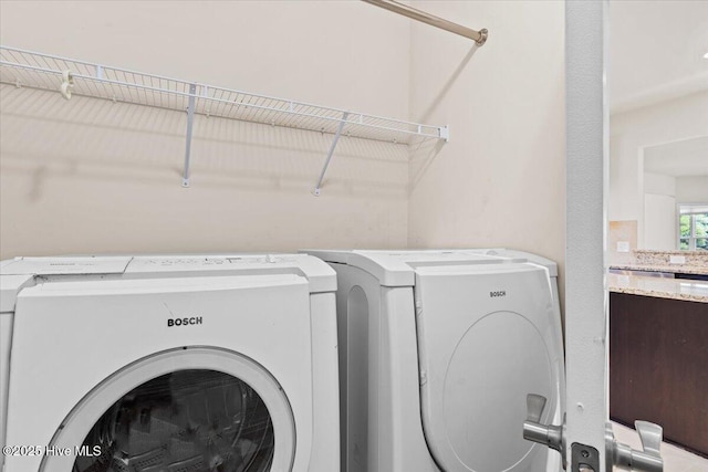 laundry area with washing machine and dryer