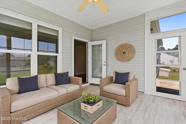 sunroom / solarium with a ceiling fan and an outdoor hangout area