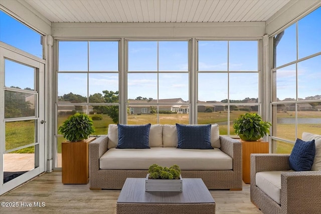 sunroom / solarium with a wooden deck and wood finished floors