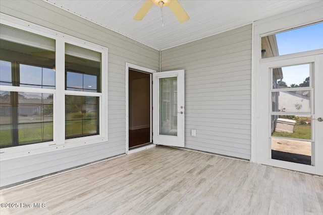 unfurnished sunroom featuring ceiling fan