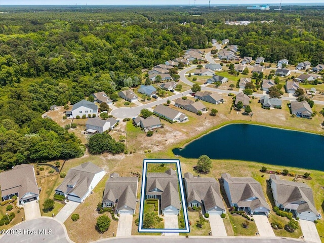 bird's eye view featuring a water view, a view of trees, and a residential view