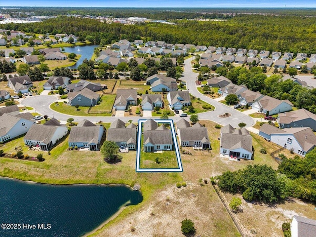 birds eye view of property featuring a water view and a residential view