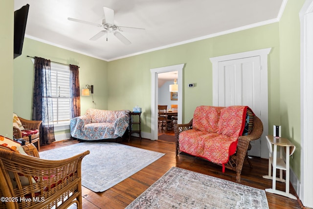 312 E W St, Southport, NC 28461 - living room featuring ceiling fan, hardwood / wood-style flooring, ornamental molding, and baseboards