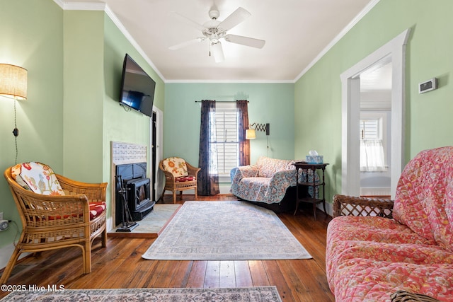 312 E W St, Southport, NC 28461 - living room featuring hardwood / wood-style floors, ornamental molding, and a ceiling fan