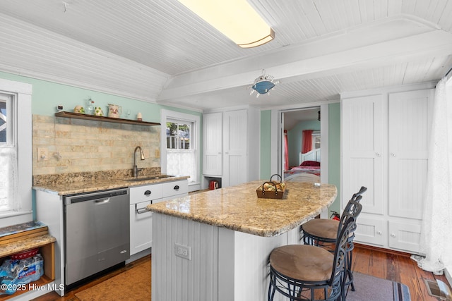312 E W St, Southport, NC 28461 - kitchen with dishwasher, a sink, a kitchen breakfast bar, a kitchen island, and light stone countertops