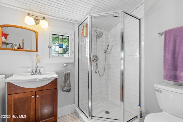 312 E W St, Southport, NC 28461 - bathroom with a shower stall, toilet, vanity, and tile patterned flooring