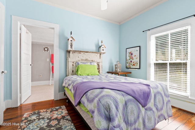 312 E W St, Southport, NC 28461 - bedroom featuring wood finished floors, crown molding, and baseboards