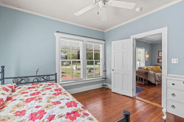 312 E W St, Southport, NC 28461 - bedroom with dark wood-style floors, ornamental molding, and ceiling fan