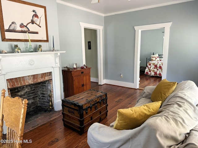 312 E W St, Southport, NC 28461 - living room featuring crown molding, hardwood / wood-style floors, a brick fireplace, and baseboards