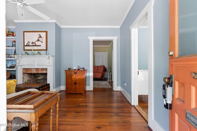 312 E W St, Southport, NC 28461 - entryway with a ceiling fan, dark wood-style flooring, ornamental molding, baseboards, and a fireplace