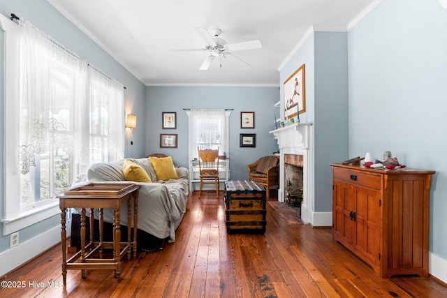 312 E W St, Southport, NC 28461 - living area with dark wood-style flooring, healthy amount of natural light, a ceiling fan, and crown molding