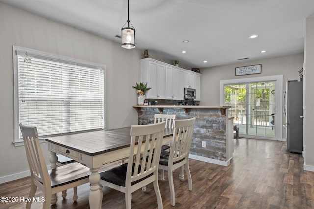dining room featuring baseboards, dark wood-style floors, and recessed lighting