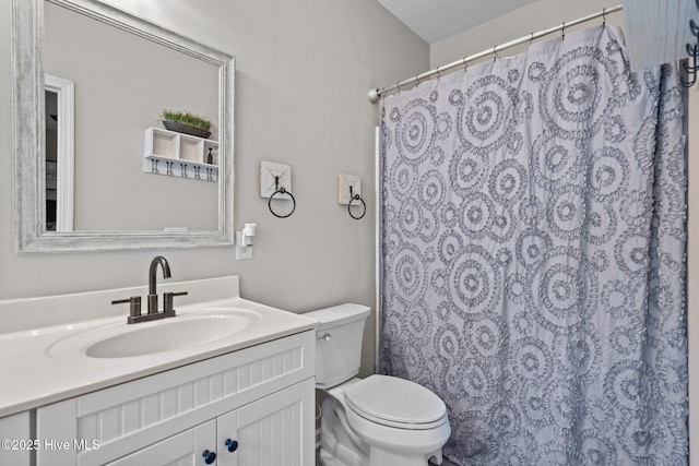 full bathroom with toilet, vanity, and a shower with curtain