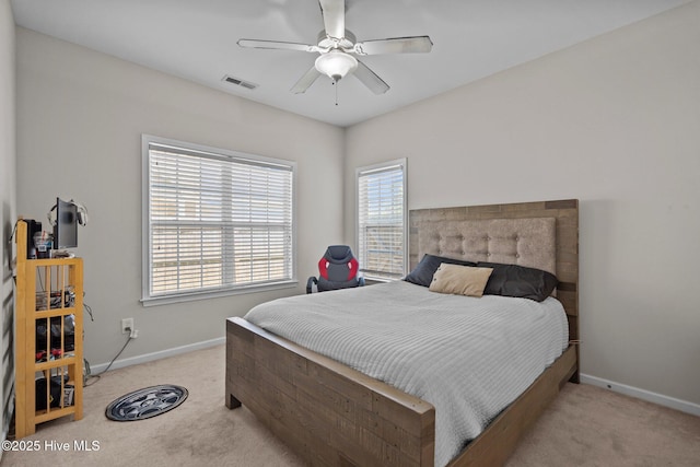 bedroom featuring light carpet, baseboards, and ceiling fan