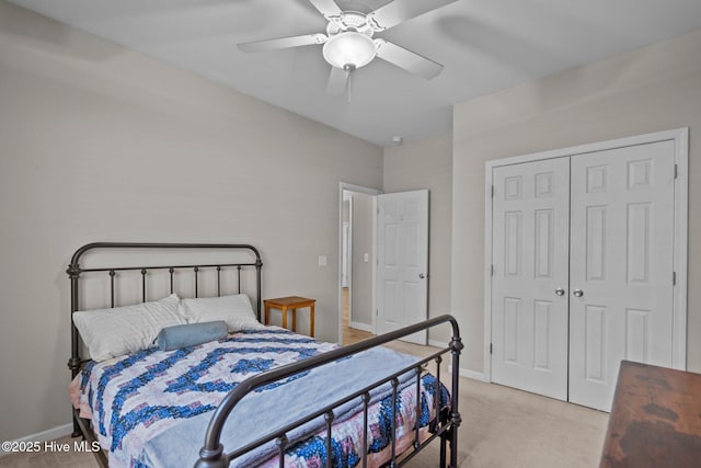bedroom featuring light carpet, baseboards, a closet, and a ceiling fan