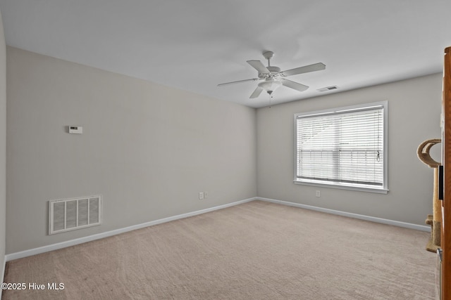 spare room featuring baseboards, a ceiling fan, and carpet