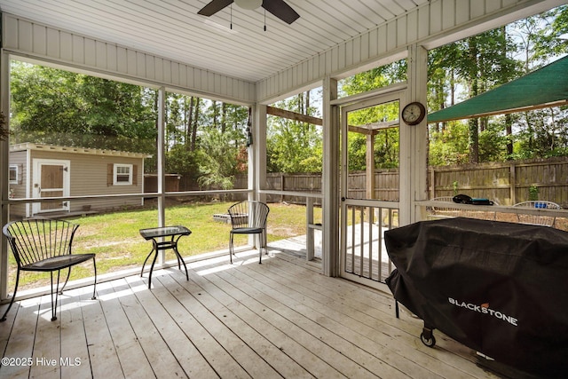 sunroom / solarium with a ceiling fan and plenty of natural light