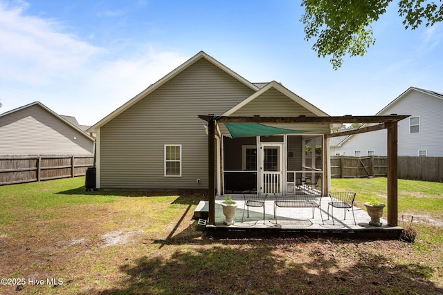 back of property featuring a sunroom and a deck
