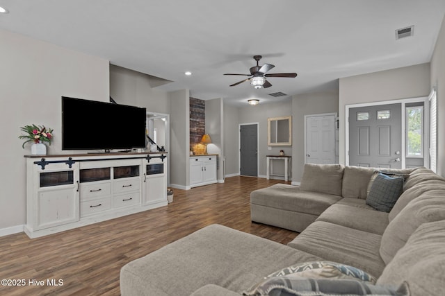 living room featuring baseboards, ceiling fan, wood finished floors, and recessed lighting