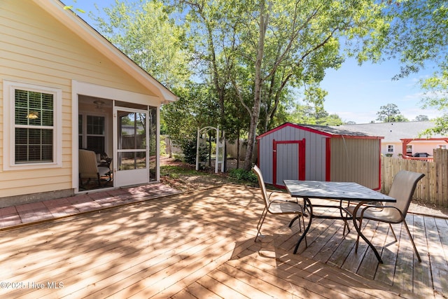 808 Tanlaw Ct, Wilmington, NC 28412 - deck with outdoor dining area, a storage unit, and a sunroom