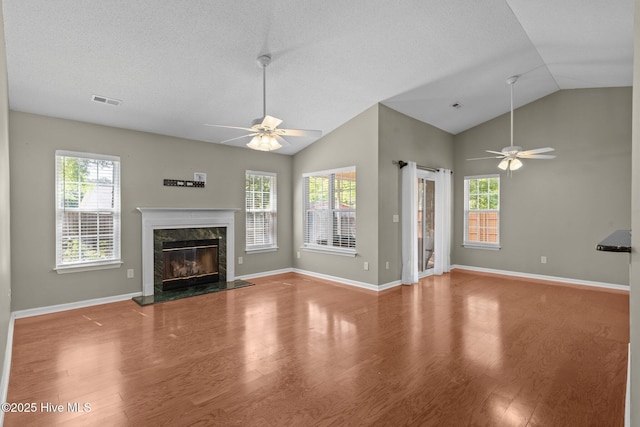 808 Tanlaw Ct, Wilmington, NC 28412 - unfurnished living room with ceiling fan, wood finished floors, lofted ceiling, plenty of natural light, and a premium fireplace